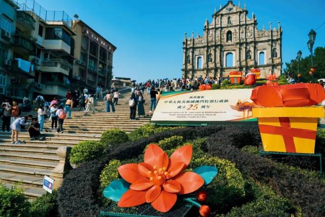 12月5日，澳門(mén)大三巴牌坊，“熱烈慶祝中華人民共和國(guó)澳門(mén)特別行政區(qū)成立25周年”的標(biāo)志吸引游客留影。圖/視覺(jué)中國(guó)